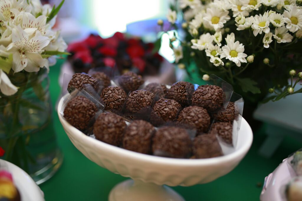 Traditional Brazilian Brigadeiro Sweets on the Table with Bouquets