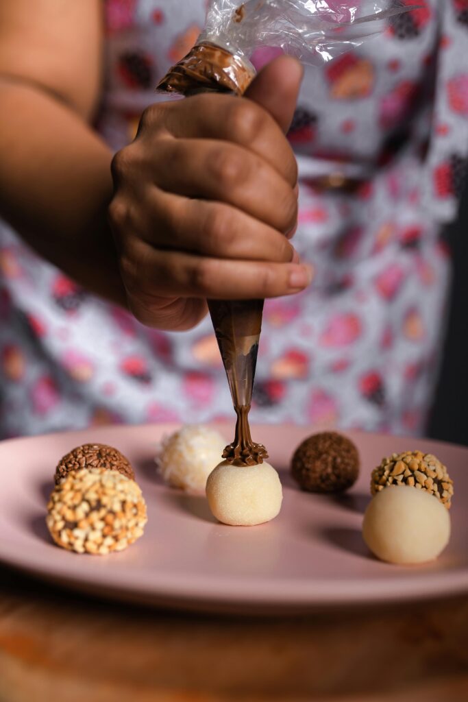 Close-up of Woman Decorating Pralines