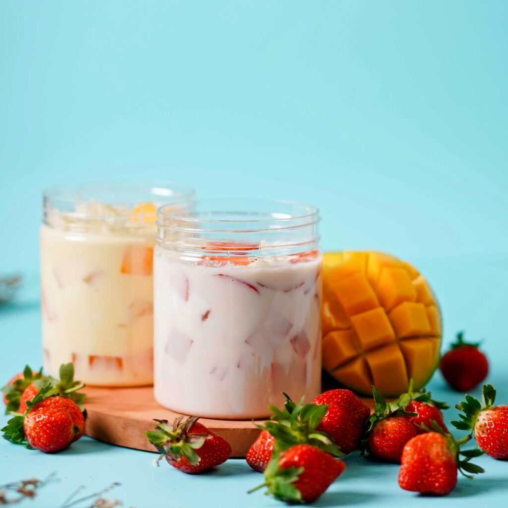 Delicious fruit yogurt with fresh mango and strawberries, perfect for a refreshing summer dessert.